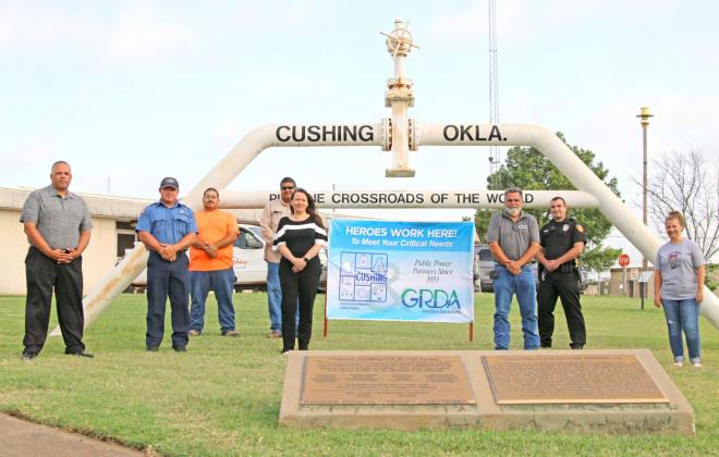 City of Cushing employees pose with the “Heroes Work Here” banner, presented by the Grand River Dam Authority. GRDA and City of Cushing have been public power partners since 1953. Pictured, back row from left, Terry Brannon, Firefighter Josh Leach, Shaun McDowell, Brent Youngman, Tina Graves, Glen Cates, Officer Cody Carpenter and Nicole Beeler.