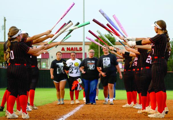 Ava Hebensperger prepares to walk through the bat tunnel with her mom Megan, and her siblings Sophia and Jackson.