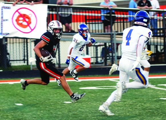 Lane Simpson sizes up the defense on his way to the end zone to score Cushing’s first touchdown of the night Friday. Photo by J. D. Meisner