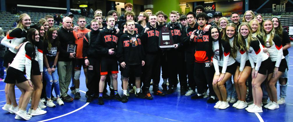 The Cushing Tiger wrestling family stands with a runners-up plaque commemorating their second place win at the OSSAA Dual State Tournament in Enid Friday, Feb. 9. See inside for more details. Photo by Allie Prater.