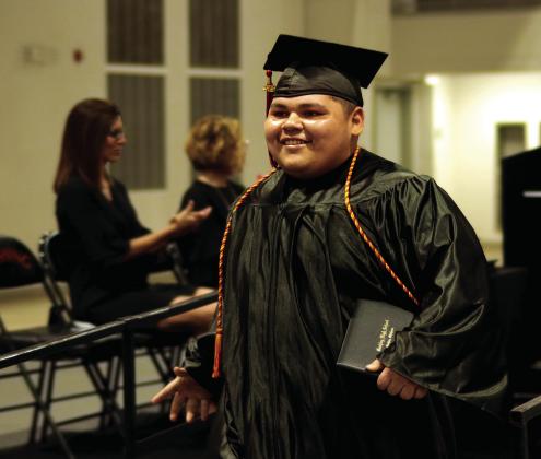 3. Nicolas “Panda” Flores beams after receiving his diploma.