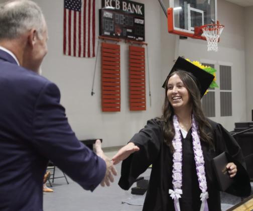 Amber Fausto shakes hands with CHS Principal Bob Coates after receiving her diploma.