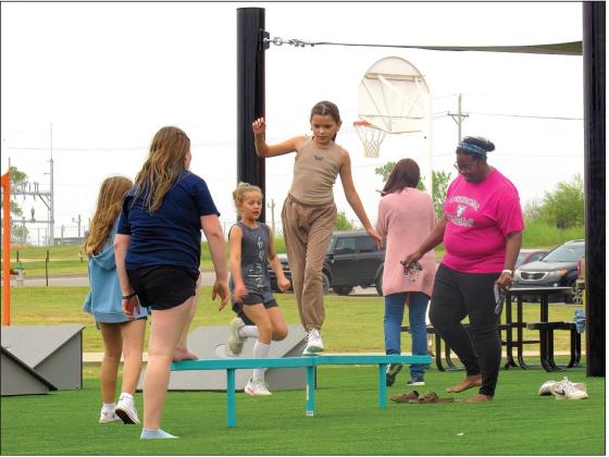 CMS fifth grade students enjoy the new playground equipment at the school building including Bella Craig who was testing her balance with a few encouraging onlookers. Photos by DeAnna Maddox