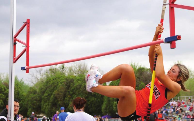 Jolie Oliver chases the bar at the Tulsa 7 Conference Meet in Bristow. Photos by Allie Prater.