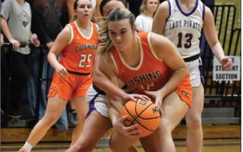 Gracyn Presley battles to maintain possession under the rim. The Cushing Lady Tigers are struggling this season with a record of 2-11.