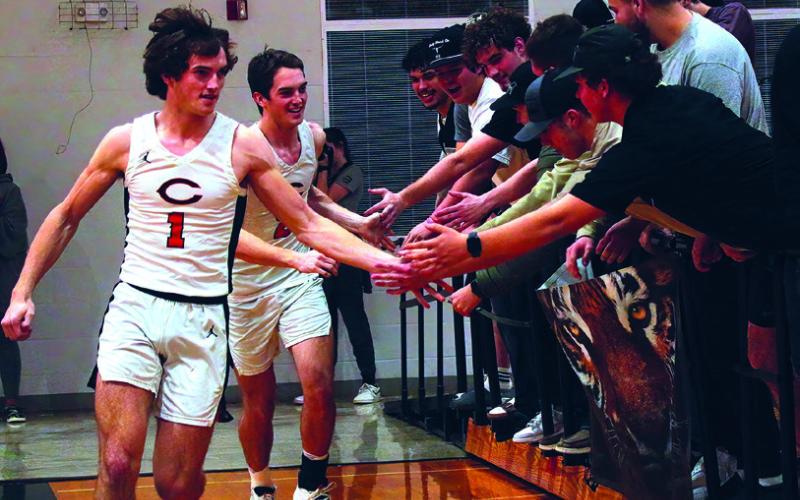 Student fans give Cushing’s Woods brothers a little love prior to their victory over Mannford las week.