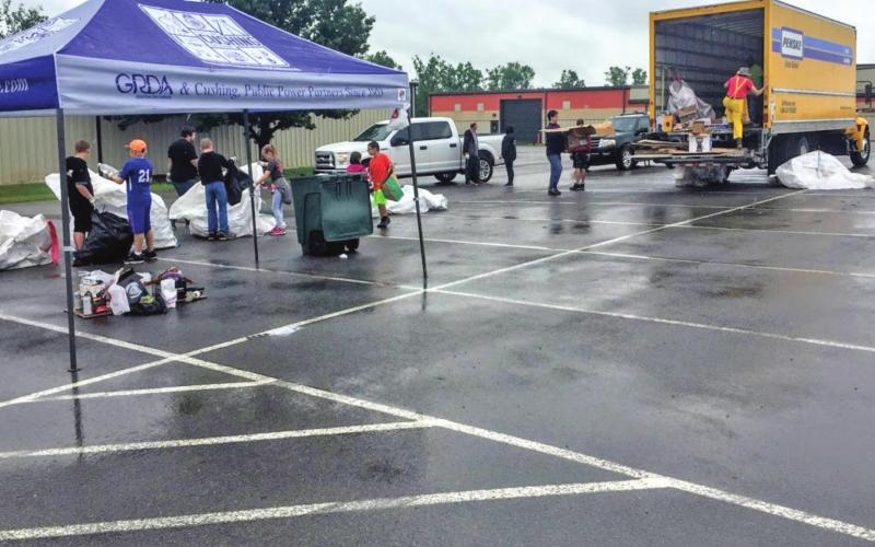 Volunteers at the first recycling event sort through items that have been dropped off.