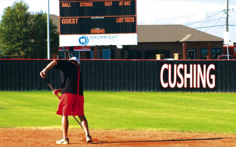 Assistant Fastpitch Coach Jeff Wintz manicures the Lady Tigers field prior to the start f the Black and Orange Scrimmage. Photo by J. D. Meisner