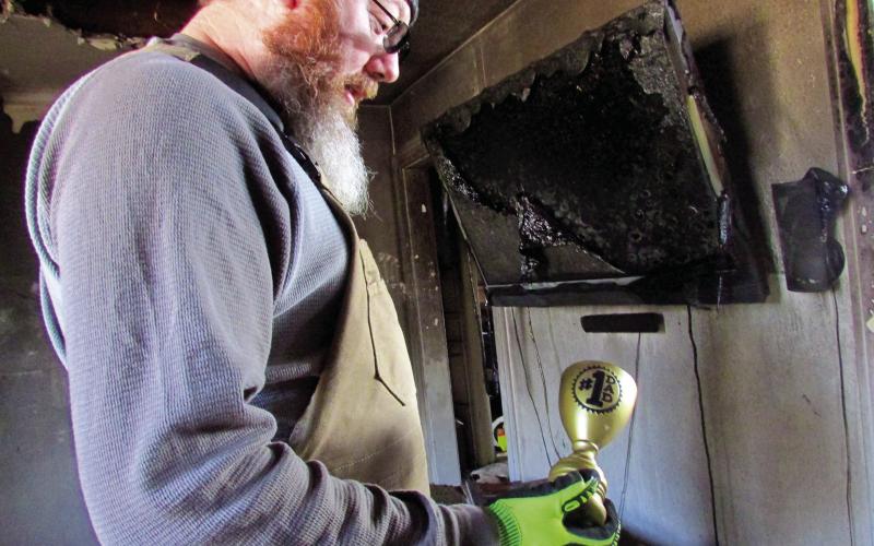 Fincher and his family went to their 12-year home in Cushing on Sunday, Jan. 8 to sift through what was left of their belongings after a fire, before returning to a hotel room until they could find a more permanent housing option. photos by DeAnna Maddox