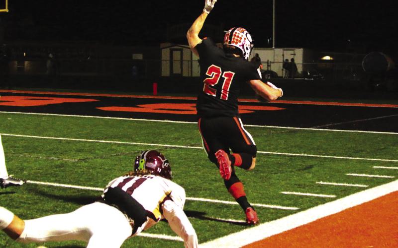 Senior Camden Crooks keeps his balance and stays in bounds during a 30- yard scamper into the endzone.