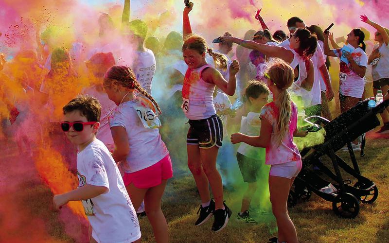 Participants in the Cushing Geographic Club’s Do or Dye fundraiser color run cause a color explosion in Memorial Park Saturday, Aug. 16 following the race. Photo by Allie Prater.