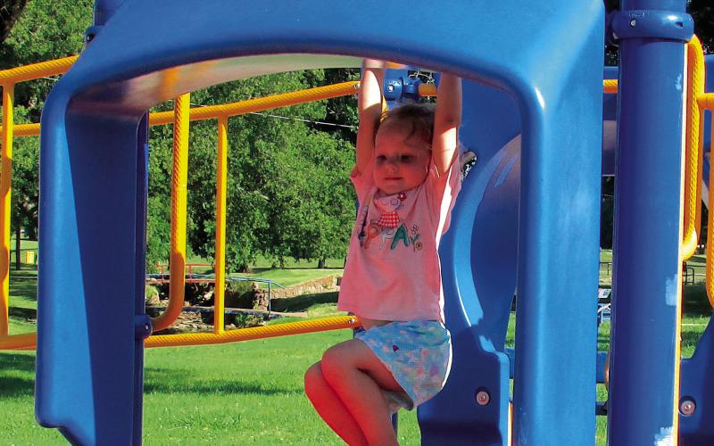 Sophie Hoover took a moment to swing before launching herself down a slide.