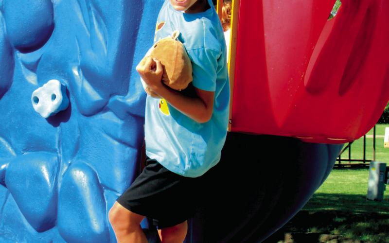 Luke Bush channels his inner tiger as he conquers the rock wall at Memorial Park.
