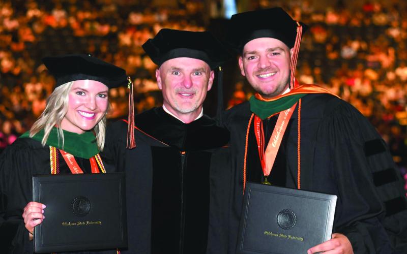 Brooke Gardner and Bingham Hightower stand with their father, Dr. Brian Hightower, between them after they officially earn the title of doctor themselves. Photo courtesy Dr. Brian Hightower.