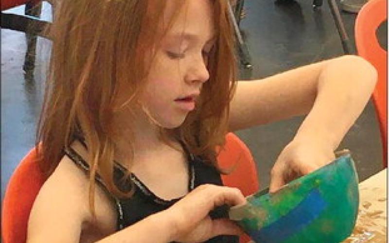 Rylee Francis preps molding clay and embraces the mess