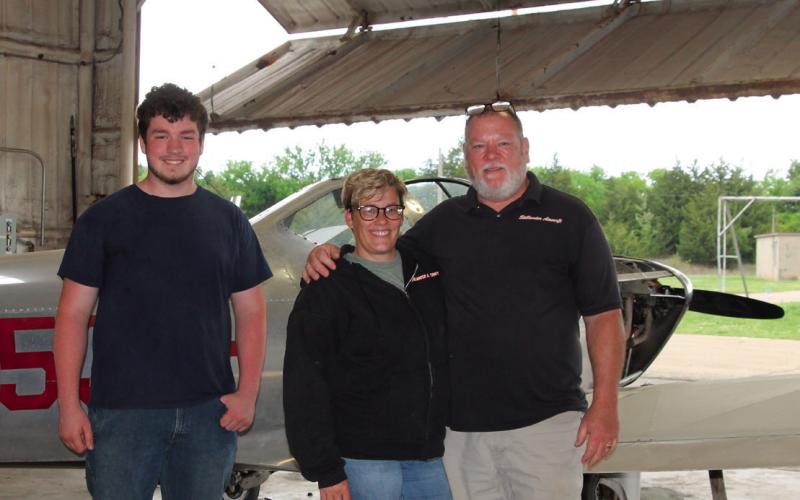 Jacob O’Kelley stands with Stillwater Aircraft Service owners Katrina and Brian Smith at the Cushing Municipal Airport. The trio will have the chance to work together during O’Kelley’s internship this summer.