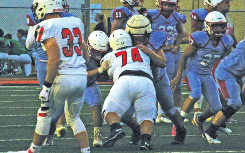 Sophomore strongman Nicolas Flores takes on two Chisolm linemen.