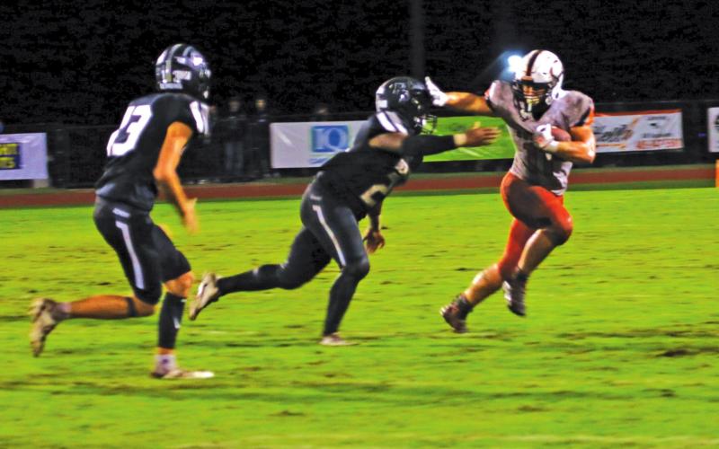 Senior fullback Haden Fry strikes a poe as he makes his way outside.