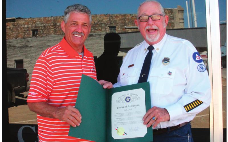 Oklahoma Representative John Talley presents Bob Lynch with a Citation of Recognition for 50 Years of Service.