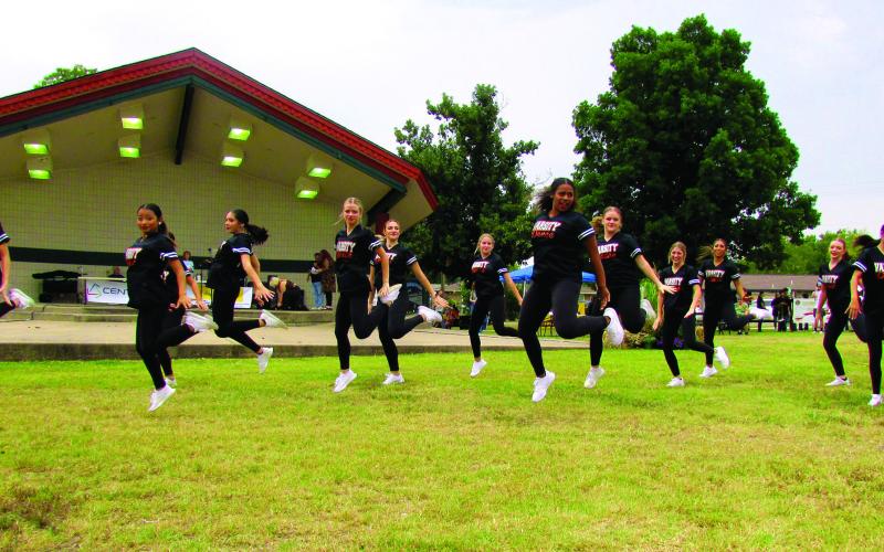 Cushing Varsity Dance team members jump and drop it down during a hip-hop performance at Festival in the Park on Saturday, Sept. 24.