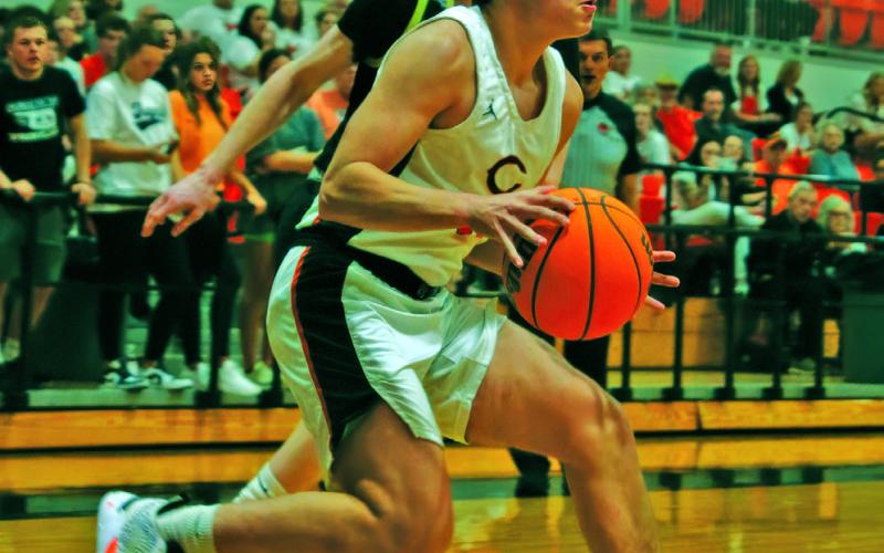 John Hilligos pulls up at the baseline in the Tigers’ 58-49 win over Woodward last week. Photos by Amber Fausto
