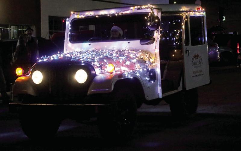 Tiger Lily’s Floral Design delivery truck spreads Christmas cheer along the parade route. Photos by Allie Prater.