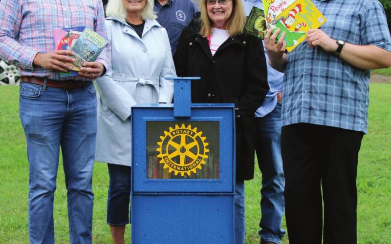 Cushing Rotarians Matt Turner, Nancy Dowell, Tyson Branyan, Tonya Rhoten, Dale Dowell and Cushing City Librarian Michael Haynes surround a new remote library