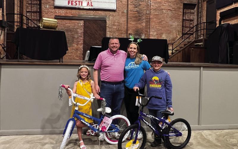 Gibble Easter Festival bicycle winners Haylee Strader and Rylan Adkison stand with festival organizers Geoff and Dawn Beasley in the Dunkin Theater after receiving their new bicycles. Photo courtesy Dawn Beasley