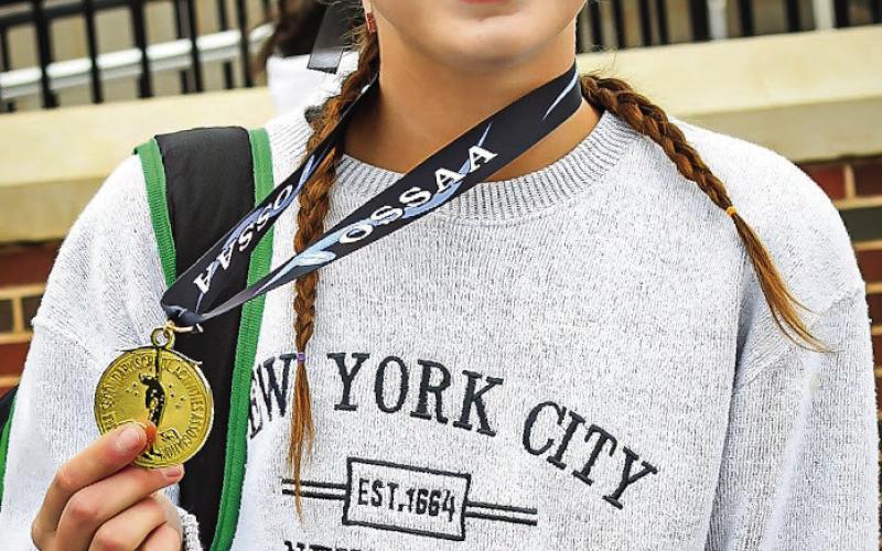 Lady Tiger senior Amaya Grant holds the medal she received after finishing third in the state at the OSSAA State Cross Country meet at Edmond Santa Fe last week.