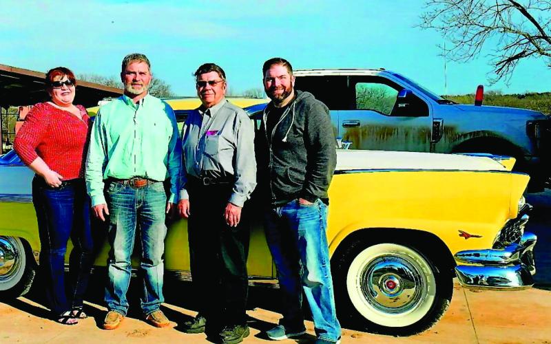 NIkki, Bret, Brad and their father Les White stand in front of the 1956 Ford Crown Victoria the kids presented to him earlier this month.