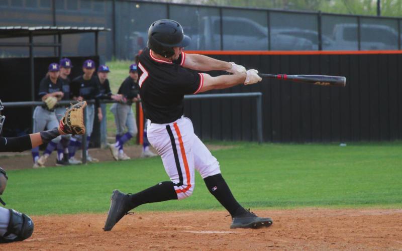 Riley Matheson sends a solo shot over the centerfield fence against Mannford last Thursday. Photos by Allie Prater