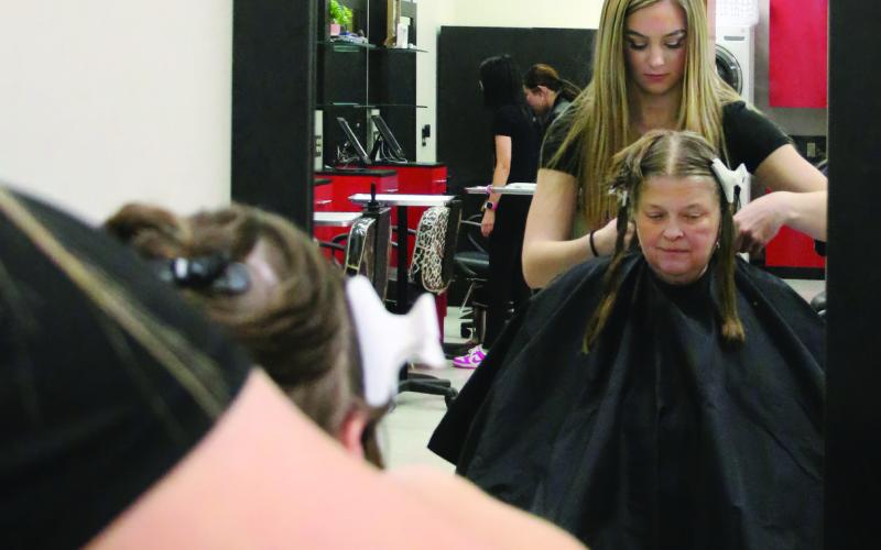 First year cosmetology student at Central Tech and Yale High School junior RyLee Reece cuts Kenna Conners’, of Bristow, hair during the Central Technology Center Open House on Sunday, Feb. 18. Photo by Allie Prater