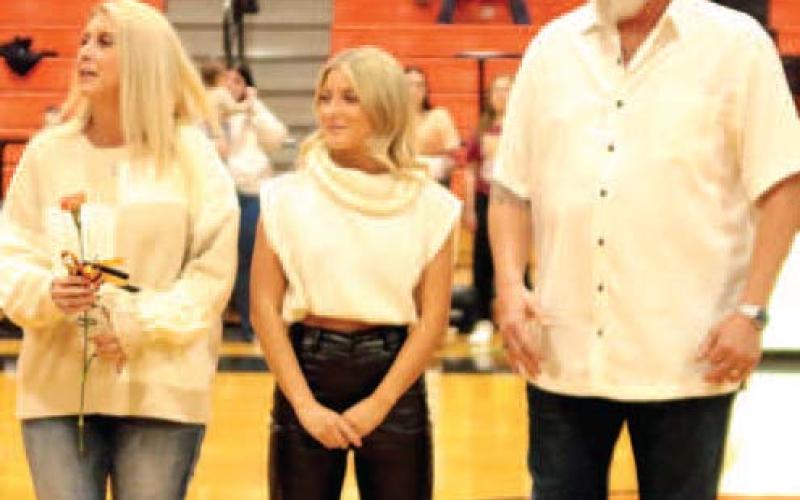 Jade Morgan escorted by her Shane and Laura Morgan.