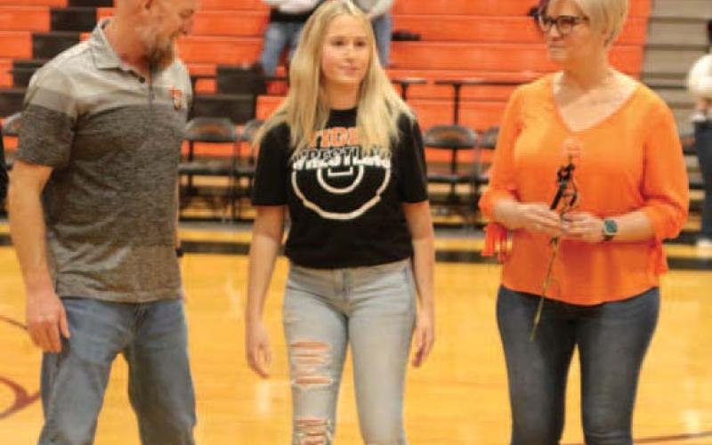 Jordyn Vaughan escorted by Eric and Destiny Vaughan
