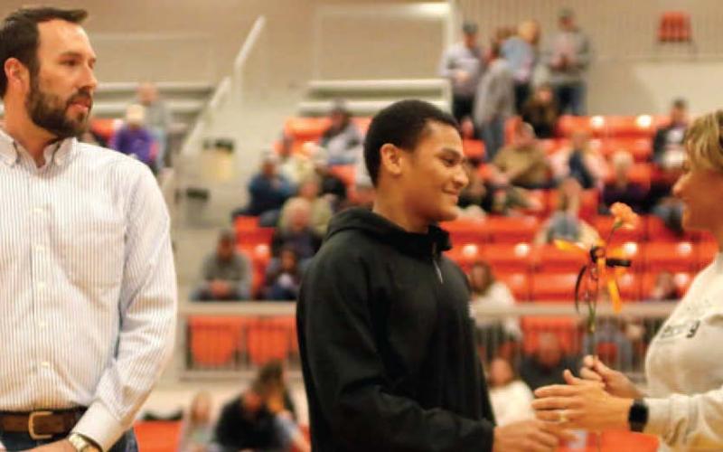 Xavier Wilson escorted by B.J. and Maria Roberson