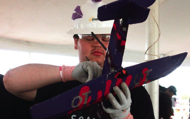 Gabe O’Kelley makes a few fi nal adjustments before his teams’ airplane takes to the sky.