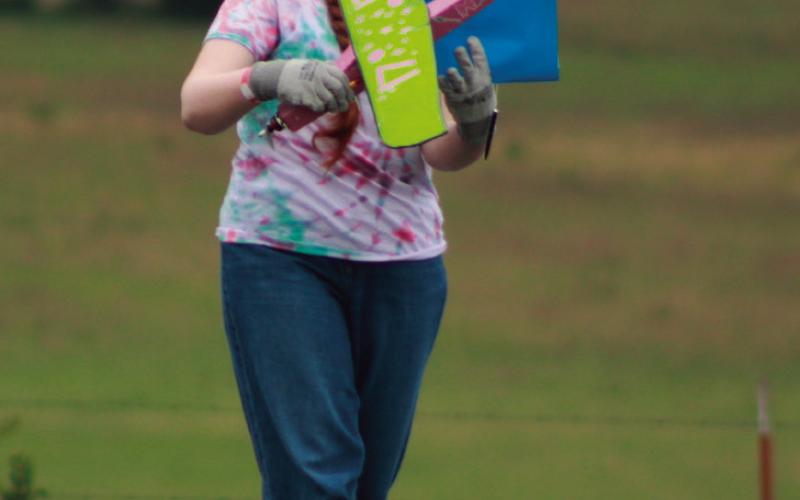 Allison Carter makes her way on the fi eld with Team 17’s airplane as she preps for another take off .