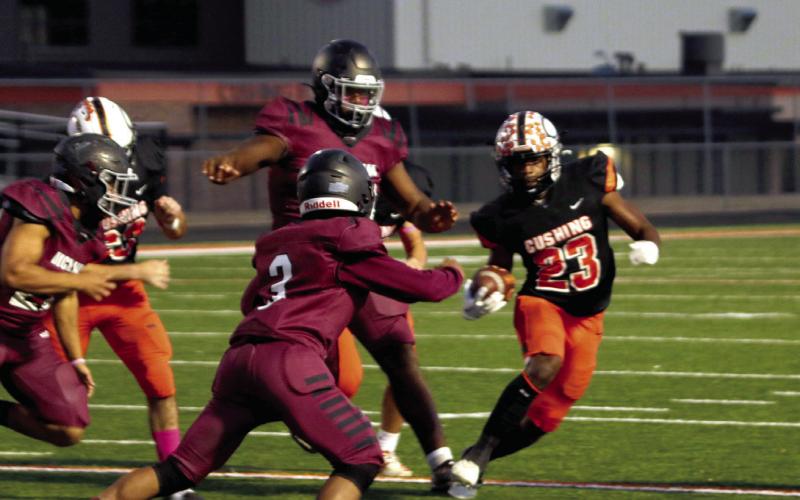 Runningback Noah Jones hits the brakes in an effort to shrug off a McClain defender Friday. Jones had 72 yards on 11 carries and scored two touchdowns. Photos by J.D. Meisner.