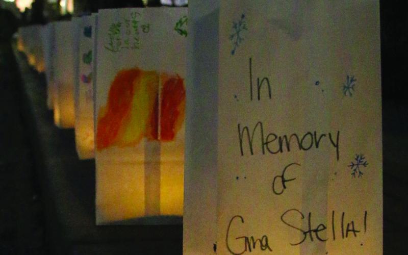 Memorial luminarias light the way for revelers on Broadway, Saturday as individuals and businesses purchased the lantern kits from DCRA members in honor of loved ones. Photo by Allie Prater