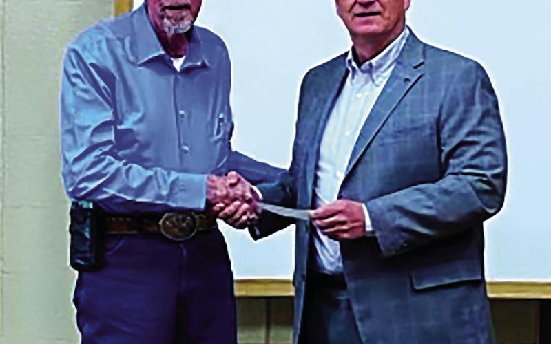Leroy Kalka, Chairman of Cushing Regional Hospital Foundation presents a check to Mid Griffith, Chairman of Cushing Board of Commissioners, for $44,051.21 to purchase a set of orthopedic operation equipment. Dr. Hanson, orthopedic surgeon, requires two sets. In the event something goes wrong during surgery, he has a backup. Dr. Hanson is now handling several cases a week at Cushing Hospital. The City of Cushing agreed to help purchase the set.