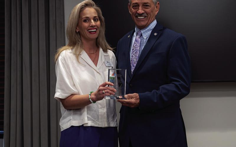 Autism Foundation of Oklahoma Executive Director Emily Scott presents Rep. John Talley with the 2023 Advocate of the Year Award.