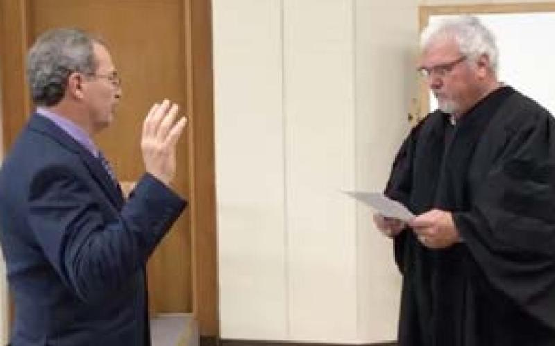Judge Bill Ahrberg swears newly elected Ricky Lofton into office.