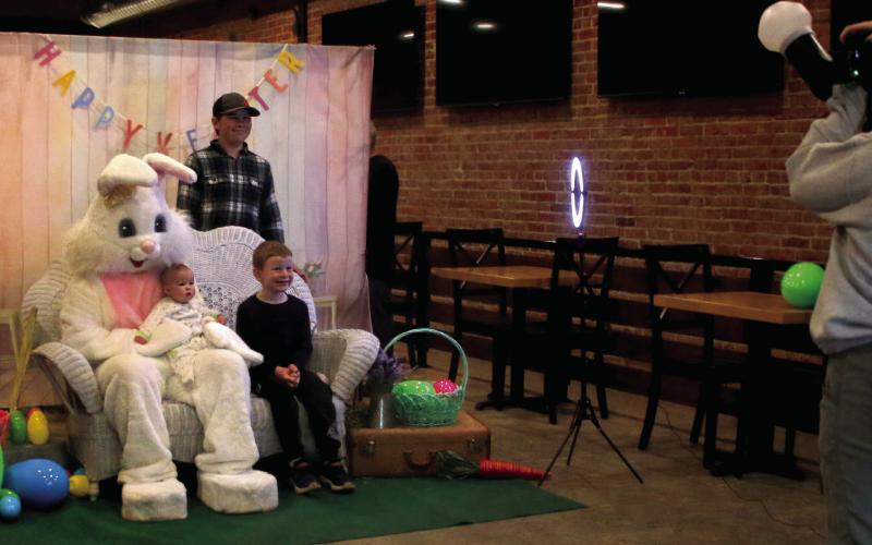 The Hamm siblings, Wyatt, Gage, and baby Ava, ham it up for their photo with the easter bunny during the Gibble Easter Festival Saturday, April 19. Photo by Allie Prater
