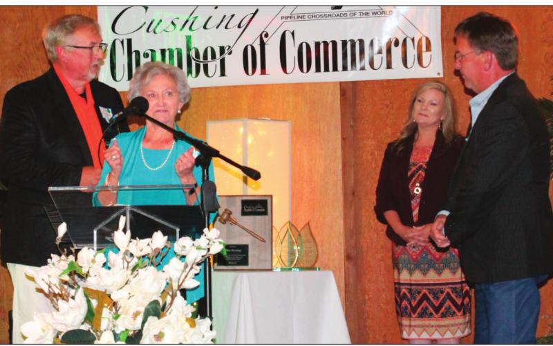 Richard Thackray, Marilyn Duff and John Moran on stage as Duff accepted the award for volunteer of the year, as well as volunteer organization of the year representing the Downtown Cushing Revitalization Association.