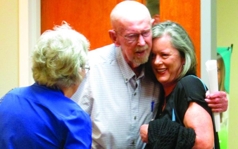 Lee Roy Kalka shares a hug with one of his daughters, Sherry, after stepping into what he was led to believe was a Cushing Regional Hospital Foundation meeting on Aug. 19 at the Cushing Hillcrest Hospital. Photo by DeAnna Maddox.