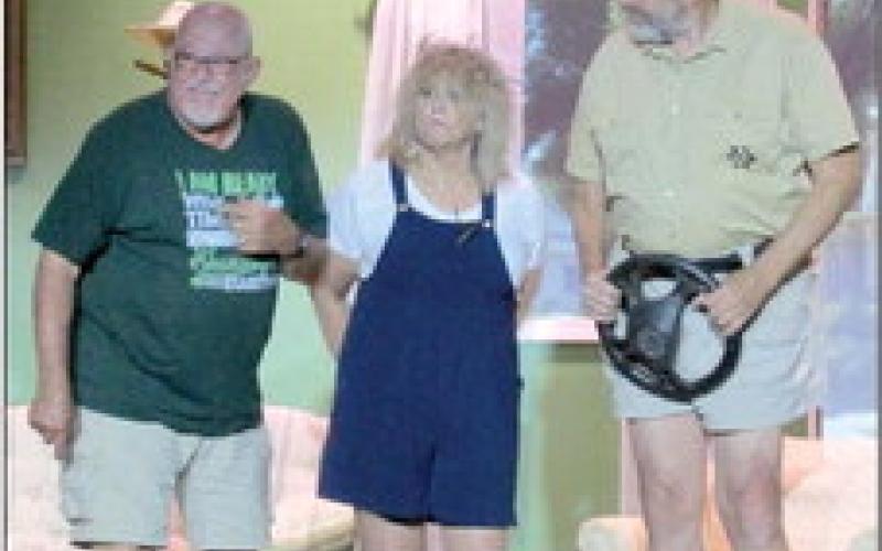 Sheriff Grover Lout (Brett Anderson) catches up with LaMerle Verdeen Minshaw (Michele Music) after a failed attempted to flee while Aubrey Verdeen (Bob Lynch) cracks another joke as the Cushing Community Theatre’s performance of “The Red Velvet Cake War” comes to an end.