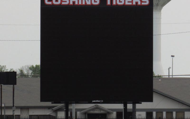 Students race across the football field in front of the recently installed Jumbotron at O’Dell Field. The digital video board will be enhancing Friday nights and other field events with live video, score board display, and eventually instant replays.