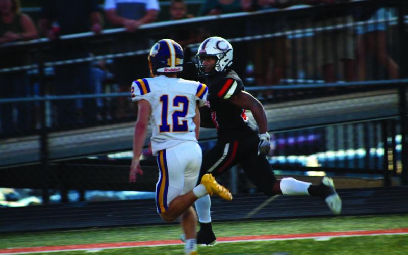Noah Jones scores and with a look says “Not today, Pirate,” to would-be tackler Braxton Estes from Bristow Friday. Jones ran for 107 yards and three touchdowns as the Tigers mauled the Pirates 63-20. Photos by J. D. Meisner
