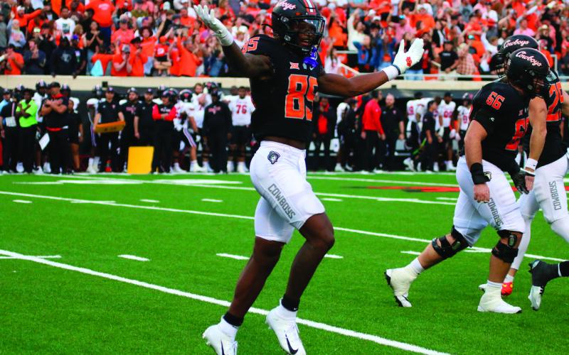 OSU’s Jaden Bray throws shrugs in celebration after a Cowboys touchdown.
