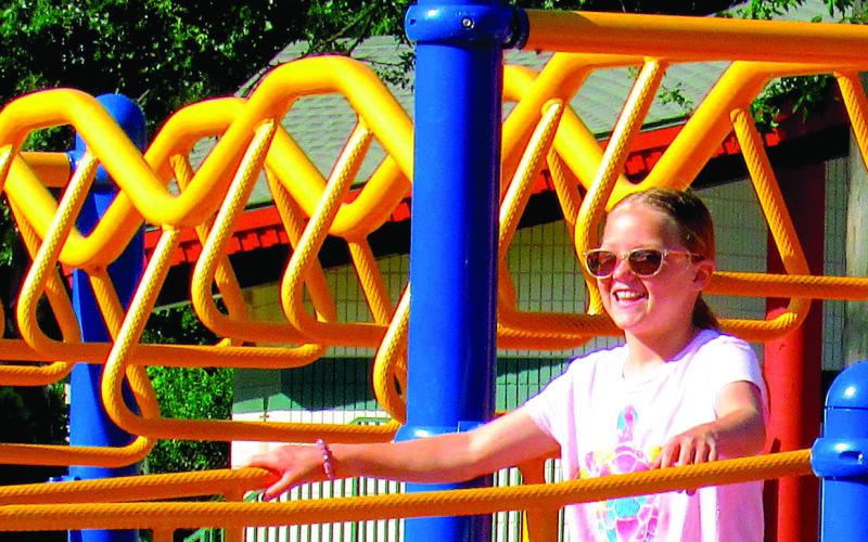 Sunshine and smiles take center stage in Memorial Park this week, as Dusti Hoover explored the playground. More sun and fun images inside. Photo by Deanna Maddox